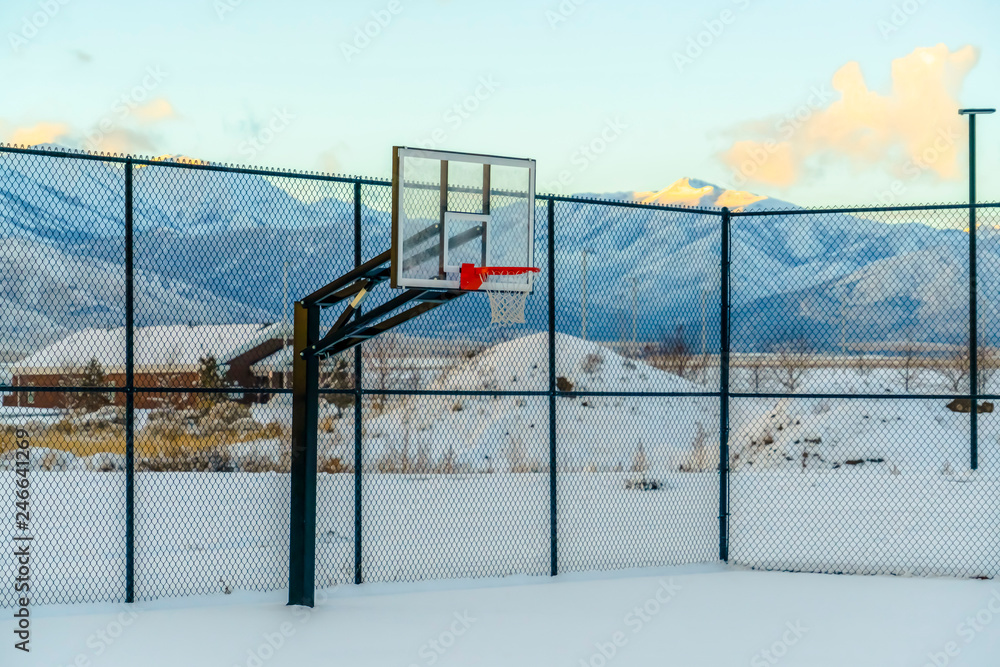 Winter scenery with basketball court and mountain Winter scenery with basketball court and mountain