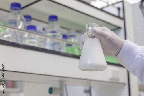 hand with white glove holding Concentrated latex