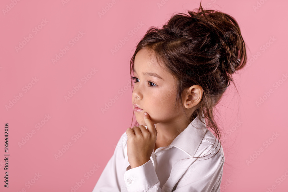 beautiful doubtful, thoughtful little girl in white shirt with hairstyle beautiful doubtful, thoughtful little girl in white shirt with hairstyle