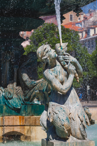 a fountain with sirens on the squre of Rossio in Lisbon
