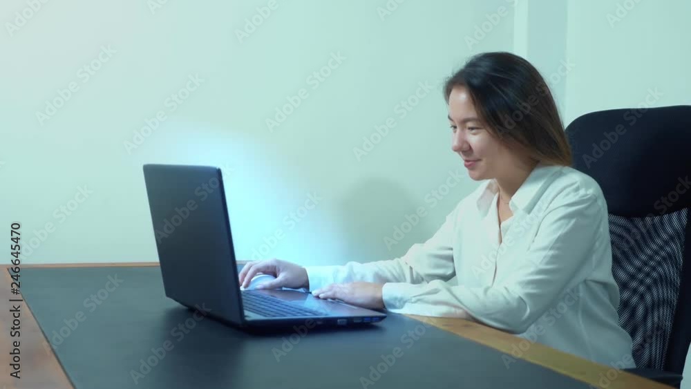 cute asian girl use laptop at table in office cute asian girl use laptop at table in office
