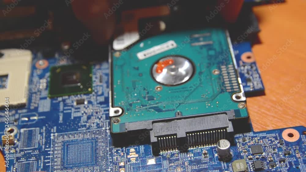 Repairman Is Connecting The SATA HDD Data Cable To The Personal repairman-is-connecting-the-sata-hdd-data-cable-to-the-personal
