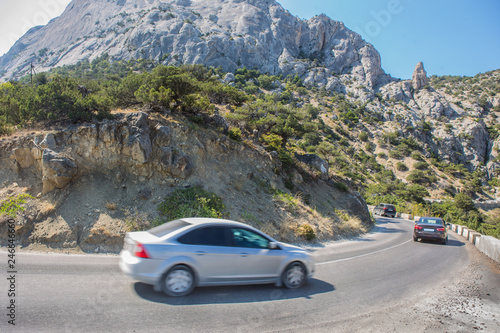 Cars Moves along a winding road in the mountains © Yuri Bizgaimer