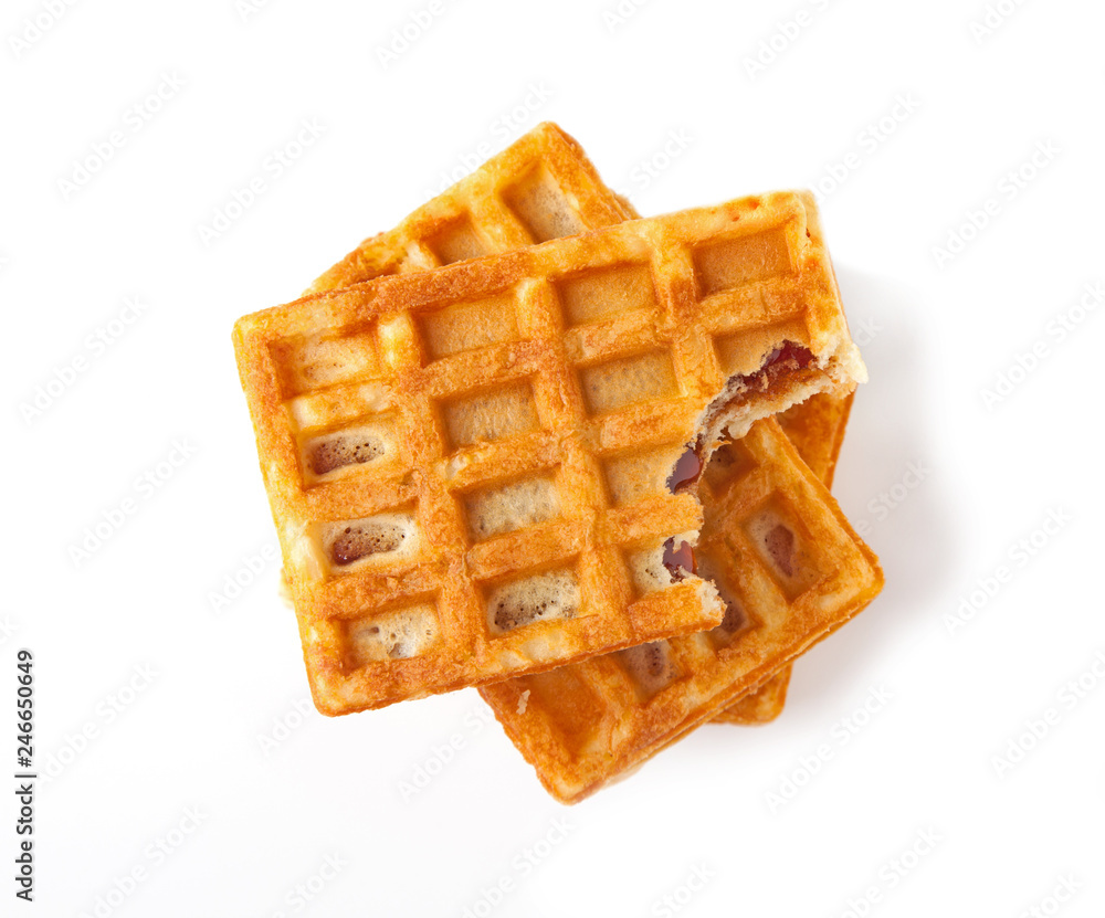 Traditional Belgian waffles, isolated on a white background, top view. Traditional Belgian waffles, isolated on a white background, top view.