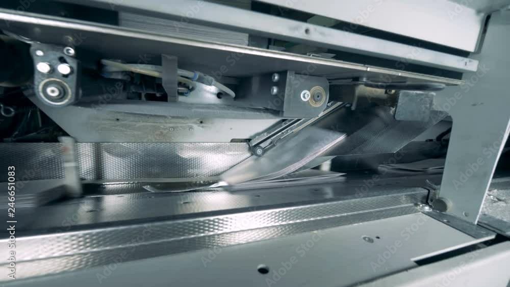 Paper is getting printed by an industrial mechanism Paper is getting printed by an industrial mechanism