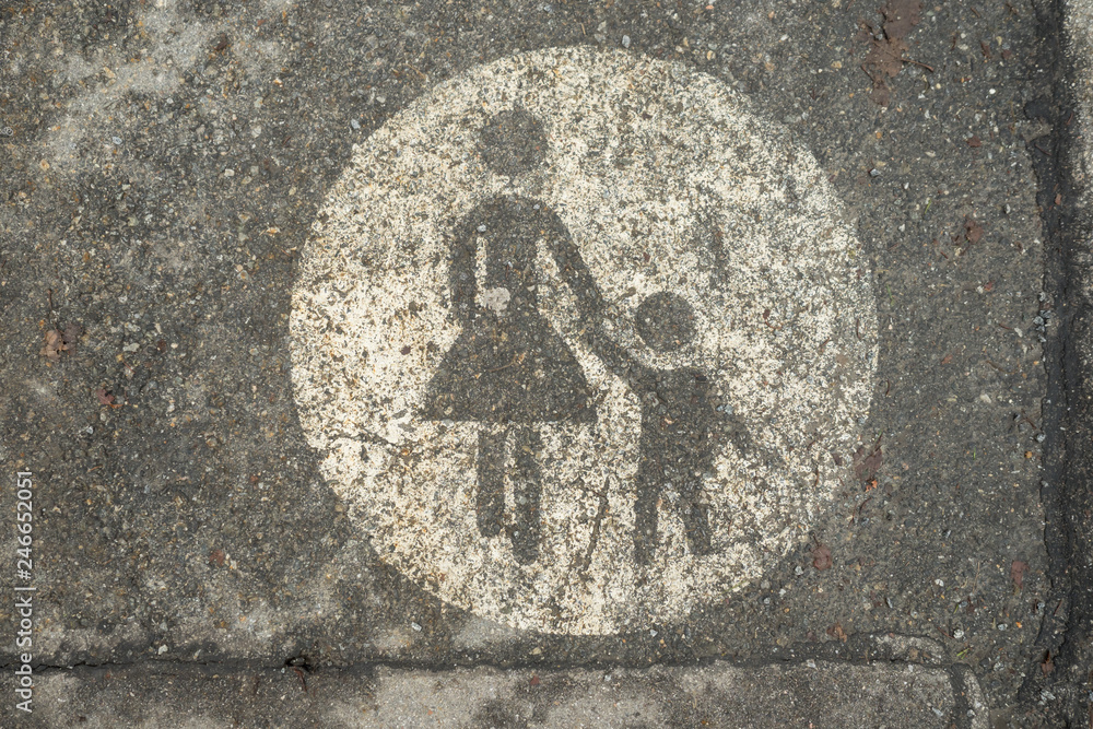 Sign on the street for pedestrian, woman and child