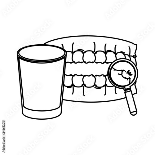 human teeth with water glass and magnifying glass