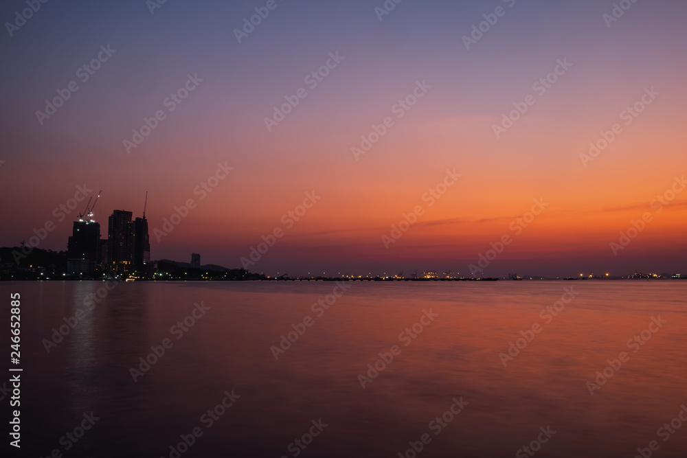 colorful sunset over city and sea
