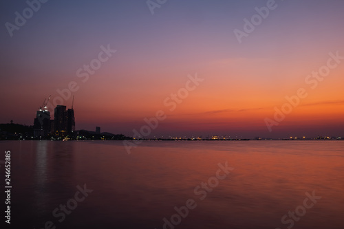 colorful sunset over city and sea