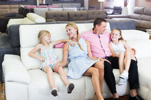 Family choosing sofa in store