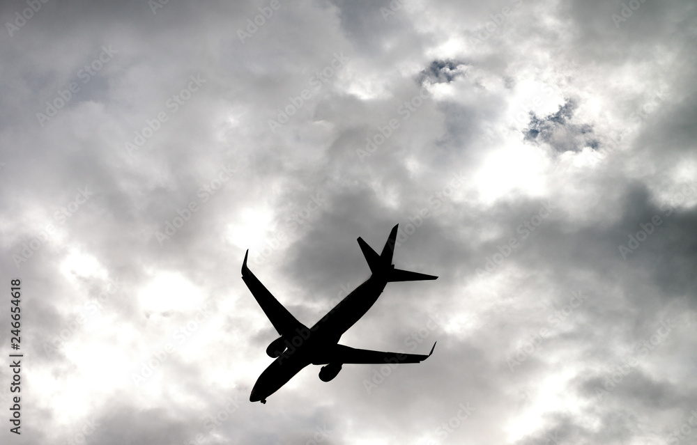 Silhouette of airplane flying high in the sky Silhouette of airplane flying high in the sky