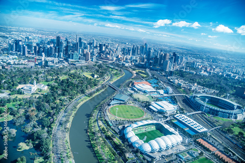 MELBOURNE - SEPTEMBER 8, 2018: Aerial view of city skyline and stadiums from helicopter. Melbourne attracts 15 million people annually