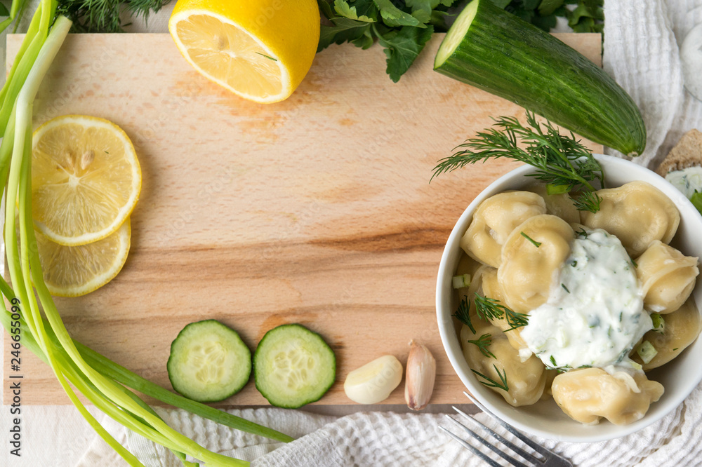 cutting Board, greens, dumplings with greens and yogurt, cucumber, lemon, garlic, food cutting Board, greens, dumplings with greens and yogurt, cucumber, lemon, garlic, food