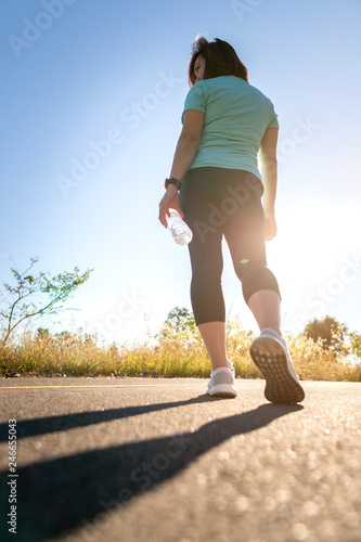 Low Section Of Woman Running On Road