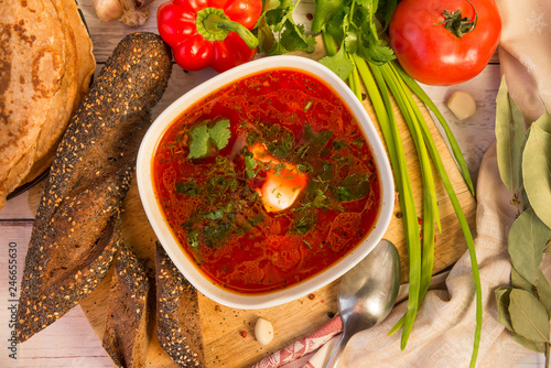 borsch with sour cream and herbs, bread, vegetables, greens, food, top view