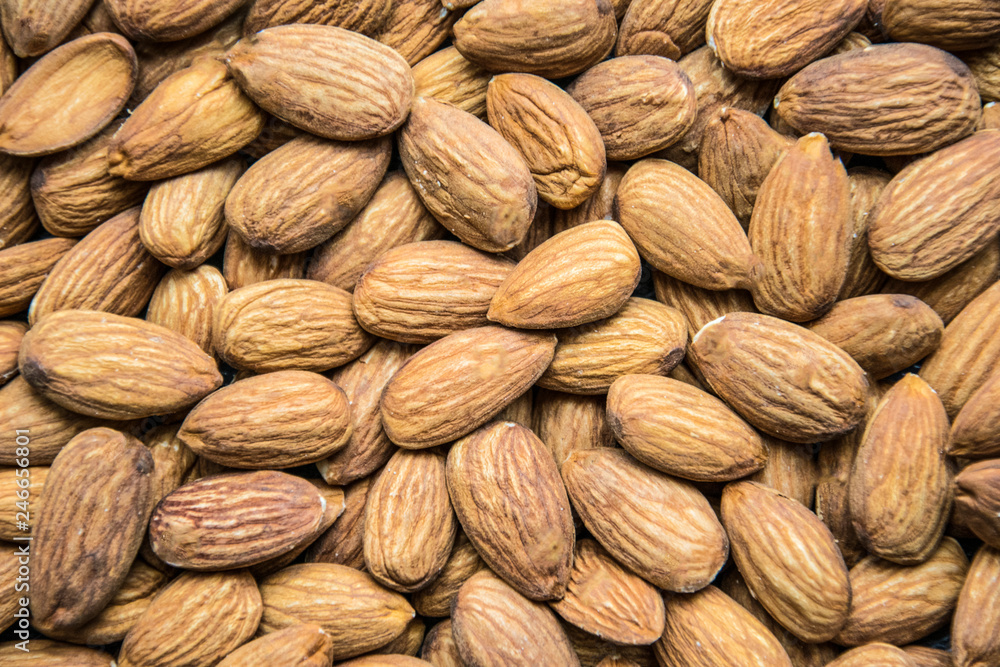 Fototapeta premium Roasted peeled almond nuts texture ,top view. Almond nuts background