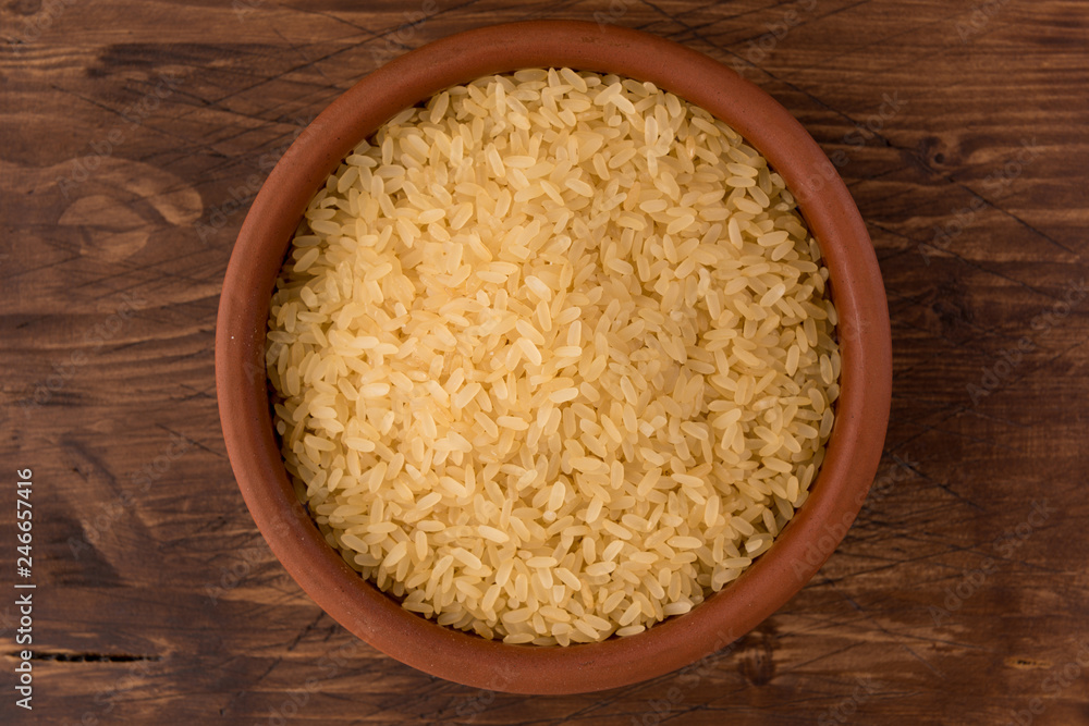white rice in bowl on wooden table background white rice in bowl on wooden table background
