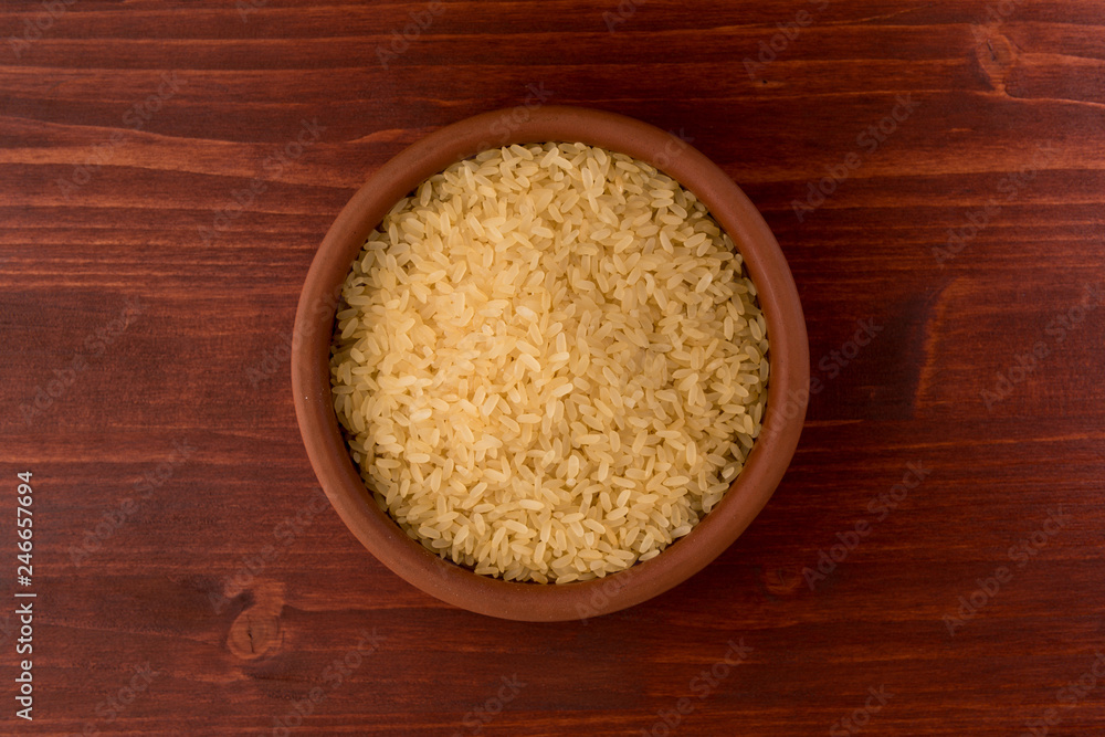 white rice in bowl on wooden table background white rice in bowl on wooden table background