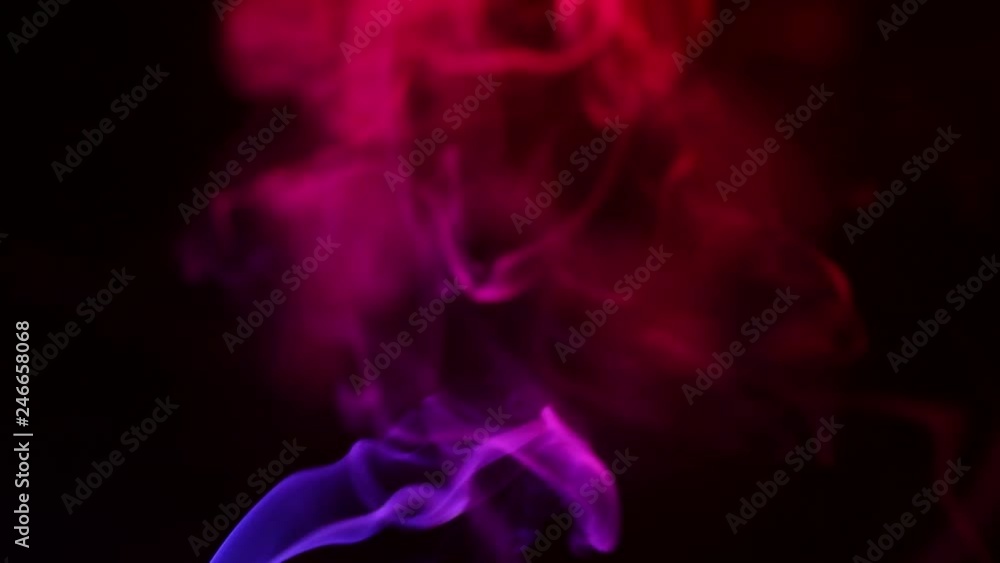 Multicolored smoke from aromatic sticks close up on black background Multicolored smoke from aromatic sticks close up on black background