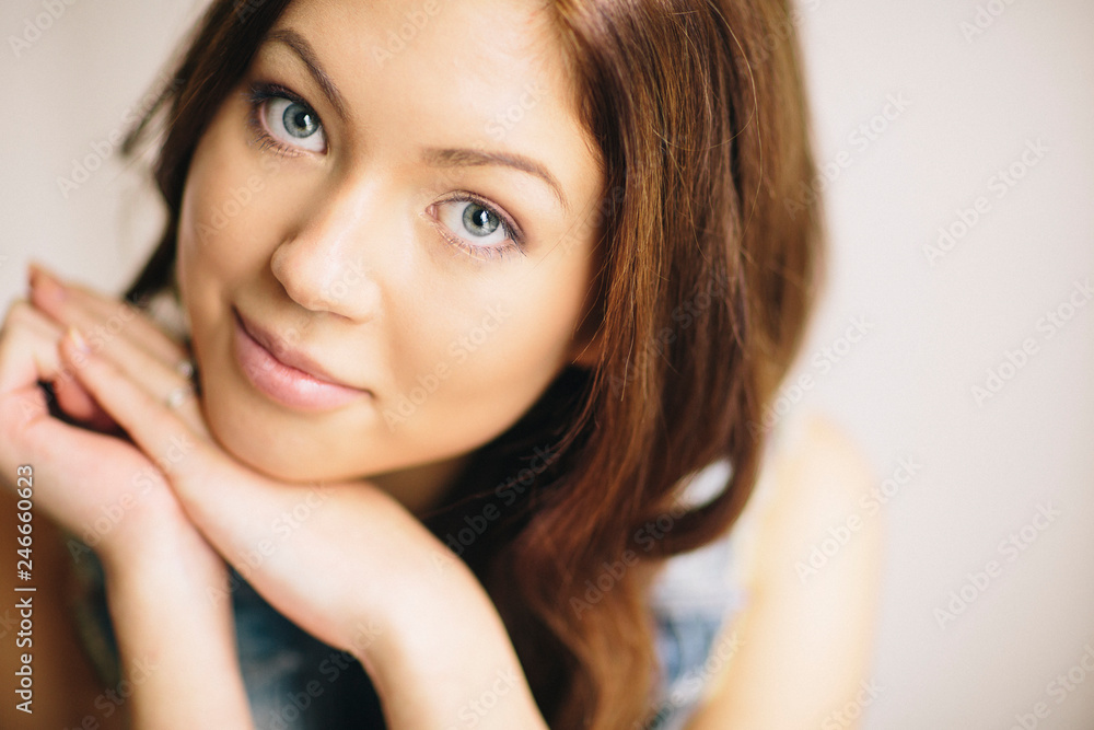 Fototapeta premium Beautiful brunette girl posing for portrait shoot in home studio
