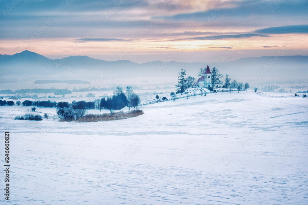 Europe, country Slovakia, region Turiec. Sunrise on winter landscape, beautiful church in the village of Abramova. Europe, country Slovakia, region Turiec. Sunrise on winter landscape, beautiful church in the village of Abramova.