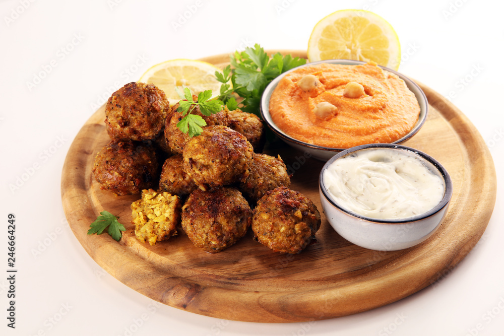 Traditional homemade hummus, falafel and chickpea served with spices on table. Jewish Cuisine.