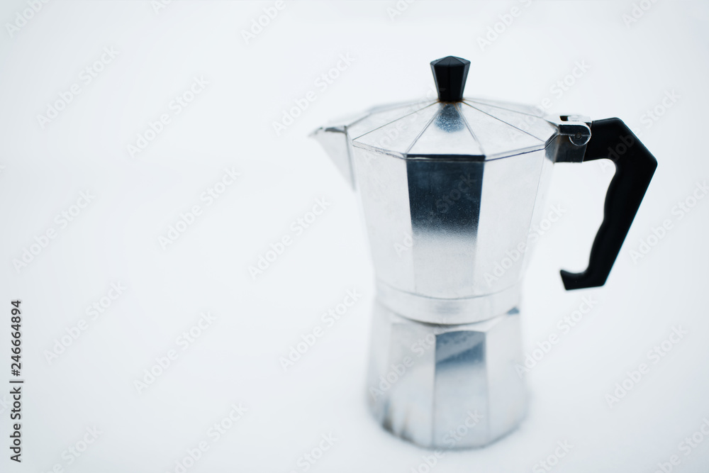 Coffee moka pot over white background on snow Coffee moka pot over white background on snow