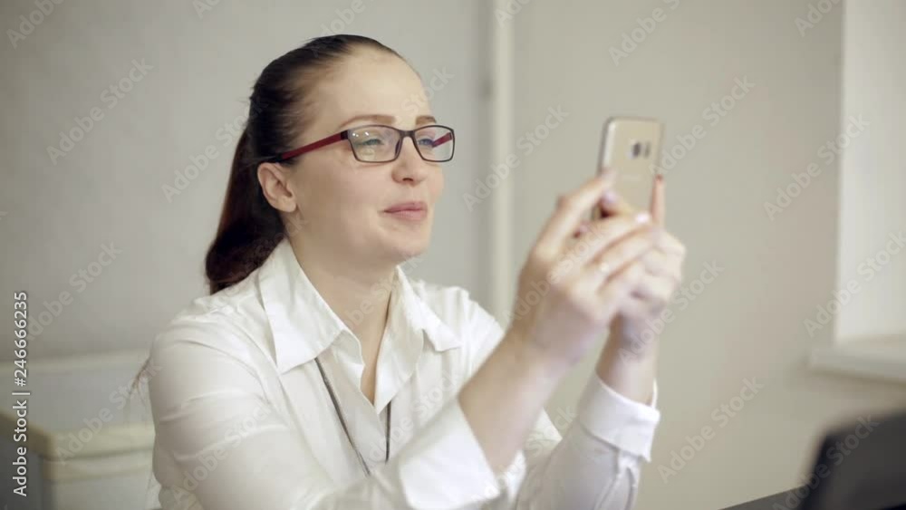 beautiful lifestyle woman with a phone in her hand in the office beautiful lifestyle woman with a phone in her hand in the office
