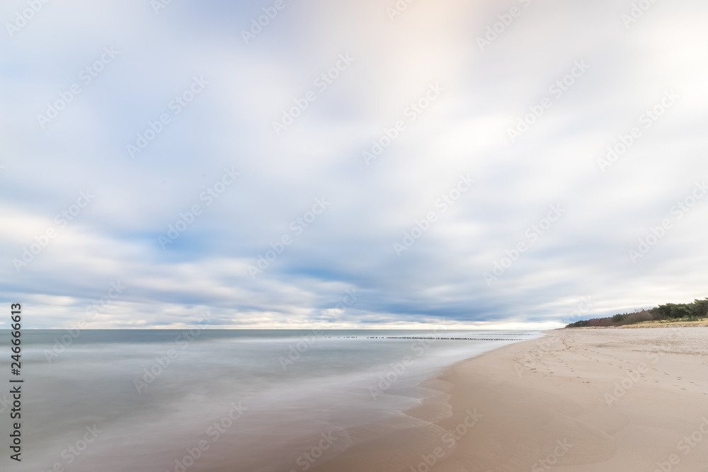 A beach in the morning with a dynamic sky