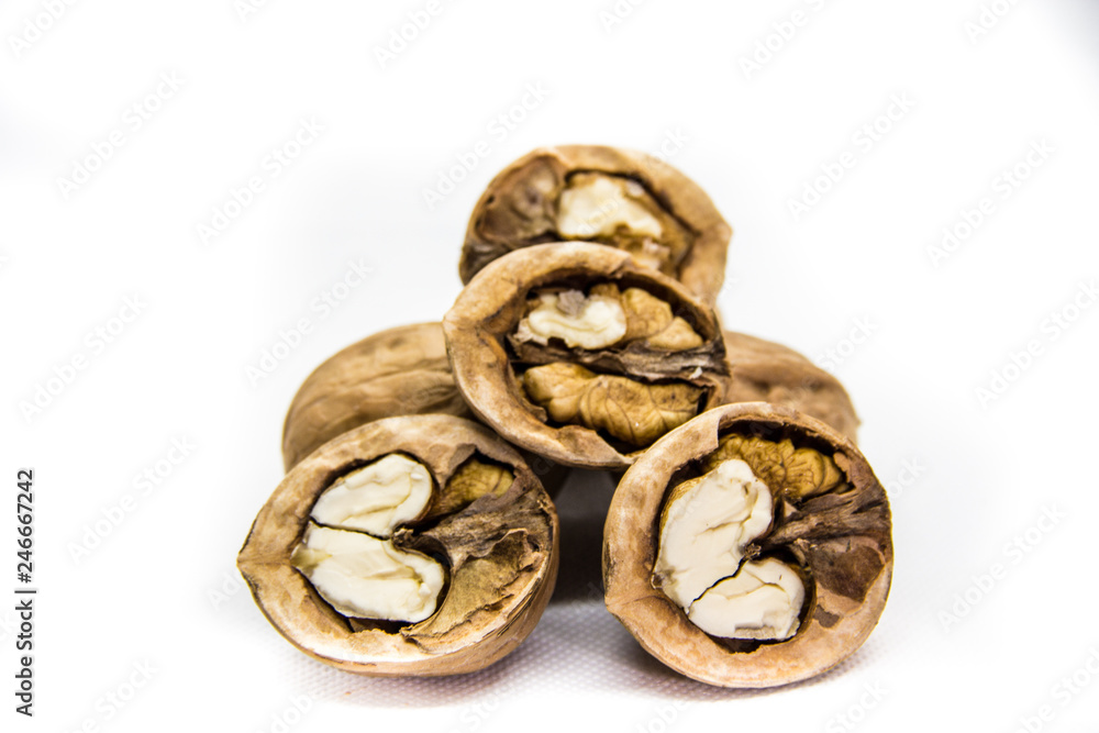 a few walnut in shell and peeled on white background
