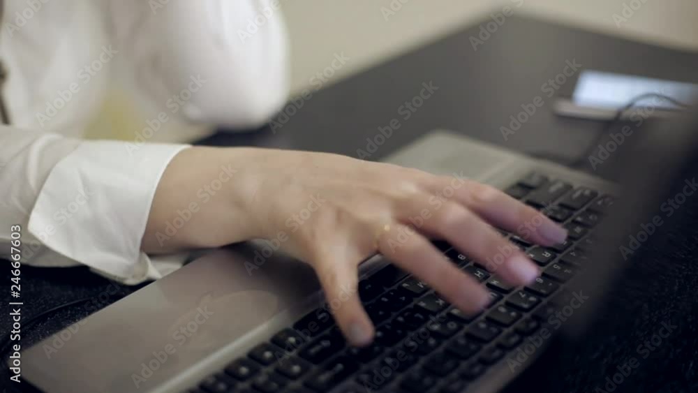 woman is typing on a laptop. Close-up woman is typing on a laptop. Close-up