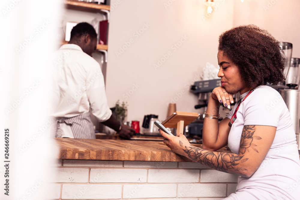 Positive nice young woman typing a message Positive nice young woman typing a message