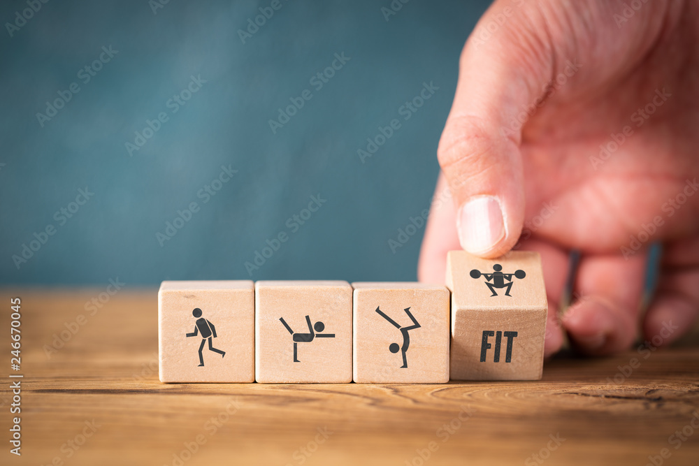 Icons on cubes symbolizing sports on wooden background - obrazy, fototapety, plakaty 