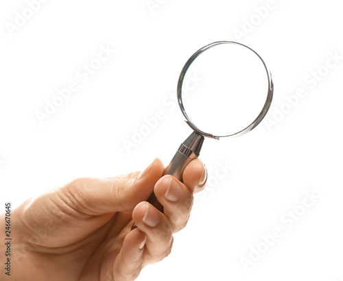 Woman holding magnifying glass on white background, closeup