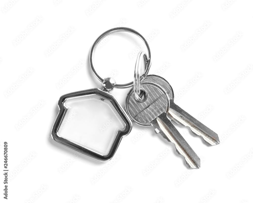 Obraz premium House keys with trinket on white background, top view