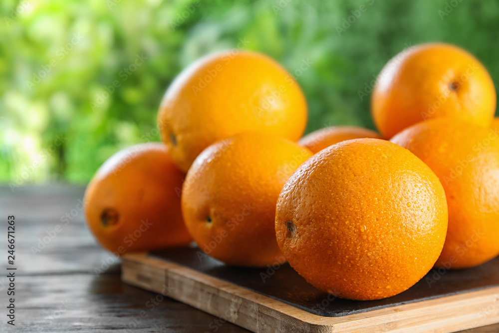 Fresh juicy oranges on wooden table. Space for text Fresh juicy oranges on wooden table. Space for text