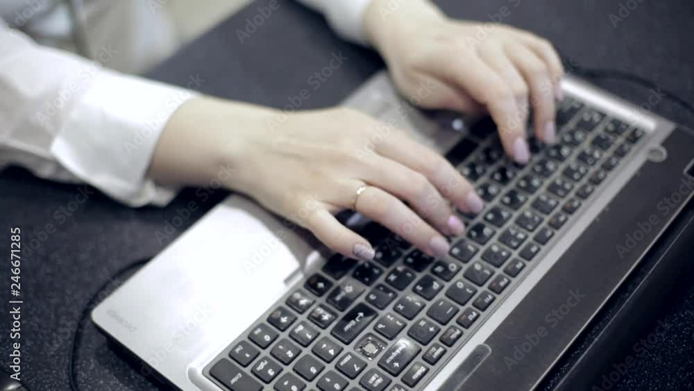 female Manager working in office at laptop in the evening female Manager working in office at laptop in the evening