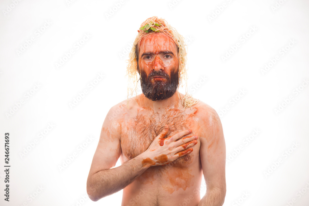 Naklejka premium Bearded, funny, young man with spaghetti on his head, white background, body, dirty
