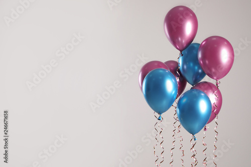 Bright balloons on light background. Space for text