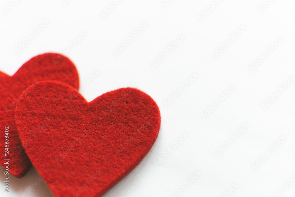 Red felt hearts on a white background. Valentine's Day
