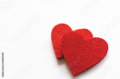 Red felt hearts on a white background. Valentine's Day