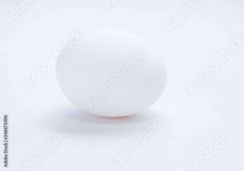 Chicken egg on a gray background. Side view