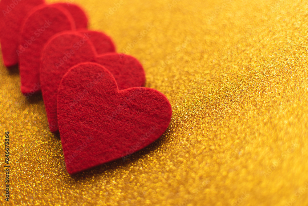 Red felt hearts on golden shiny background. Valentine's Day Red felt hearts on golden shiny background. Valentine's Day