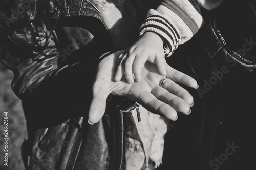 Hands of parents and child close up. Happy loving family together. Hold hands. Caring for children, support. Family day
