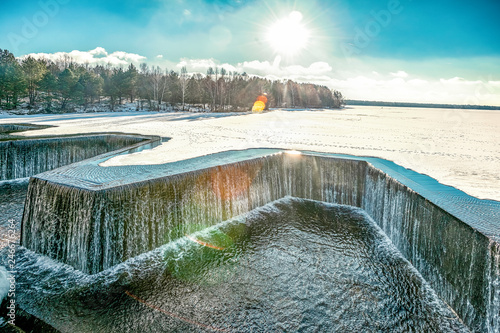  incredibly beautiful landscape on a dam with ice on the river on a sunny winter day