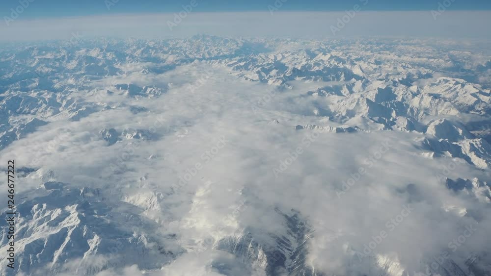 Aerial landscape of the Alps in Europe during winter season with fresh snow. View from the window of the airplane Aerial landscape of the Alps in Europe during winter season with fresh snow. View from the window of the airplane