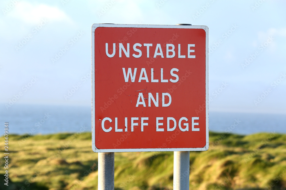 Warning Sign of unstable walls and cliff edge Warning Sign of unstable walls and cliff edge