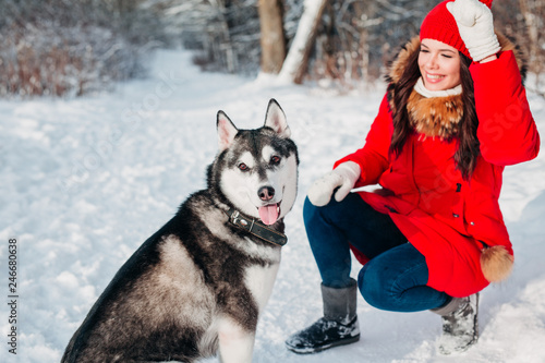 Young girl with her husky dog in winter park. Domestic pet. Husky © Elena Kratovich
