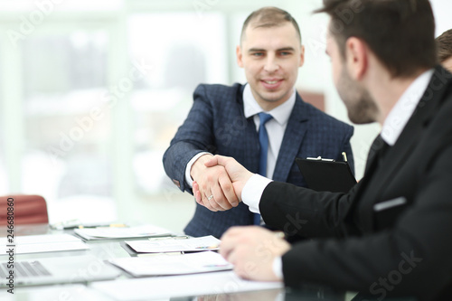 handshake trading partners at the Desk in the office