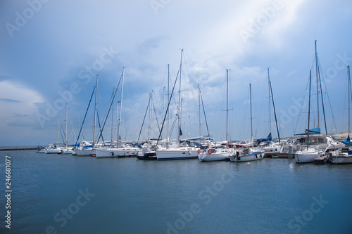 sailboats are moored on a pier